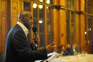 Photo is of site owner Fitzroy Andrew addressing te guests at the Annual General Meeting on the Haringey Association of Voluntary and Community Organisations in November 2011